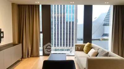 Modern living room with floor-to-ceiling windows offering stunning city views.