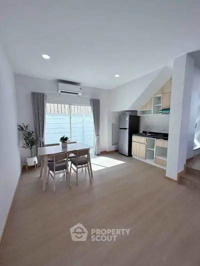 Modern open-plan kitchen and dining area with natural light and minimalist design.