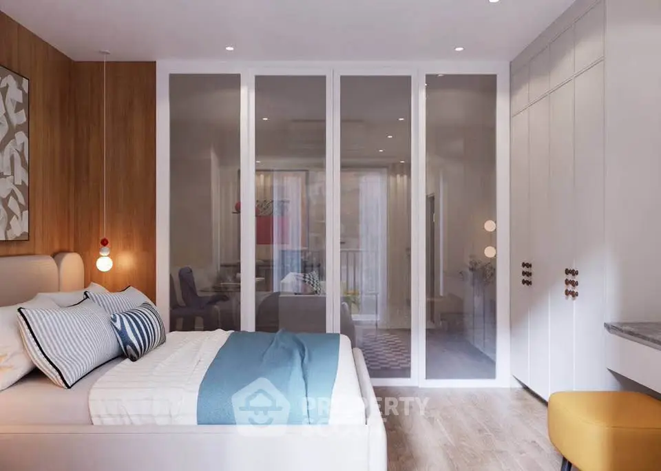 Modern bedroom with stylish decor and glass partition leading to a cozy living area.
