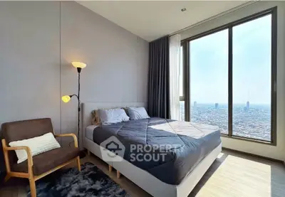 Modern bedroom with large window offering stunning city view