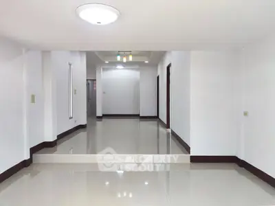 Spacious modern living room with glossy tile flooring and recessed lighting