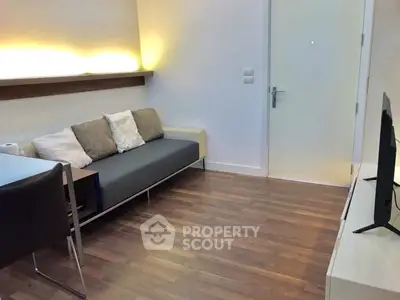 Modern living room with sleek design and cozy seating area, perfect for relaxation.