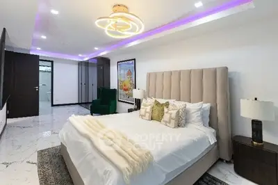 Luxurious modern bedroom with elegant lighting and plush furnishings