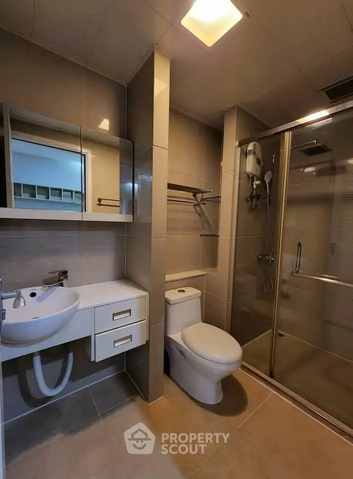 Modern bathroom with sleek fixtures and glass shower enclosure
