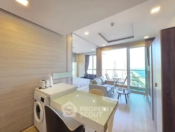 Modern open-plan apartment with washing machine and stunning view from balcony.