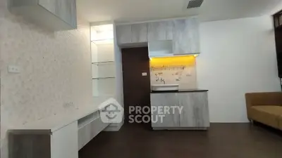 Modern living room with stylish cabinetry and cozy seating area, perfect for relaxation and entertainment.