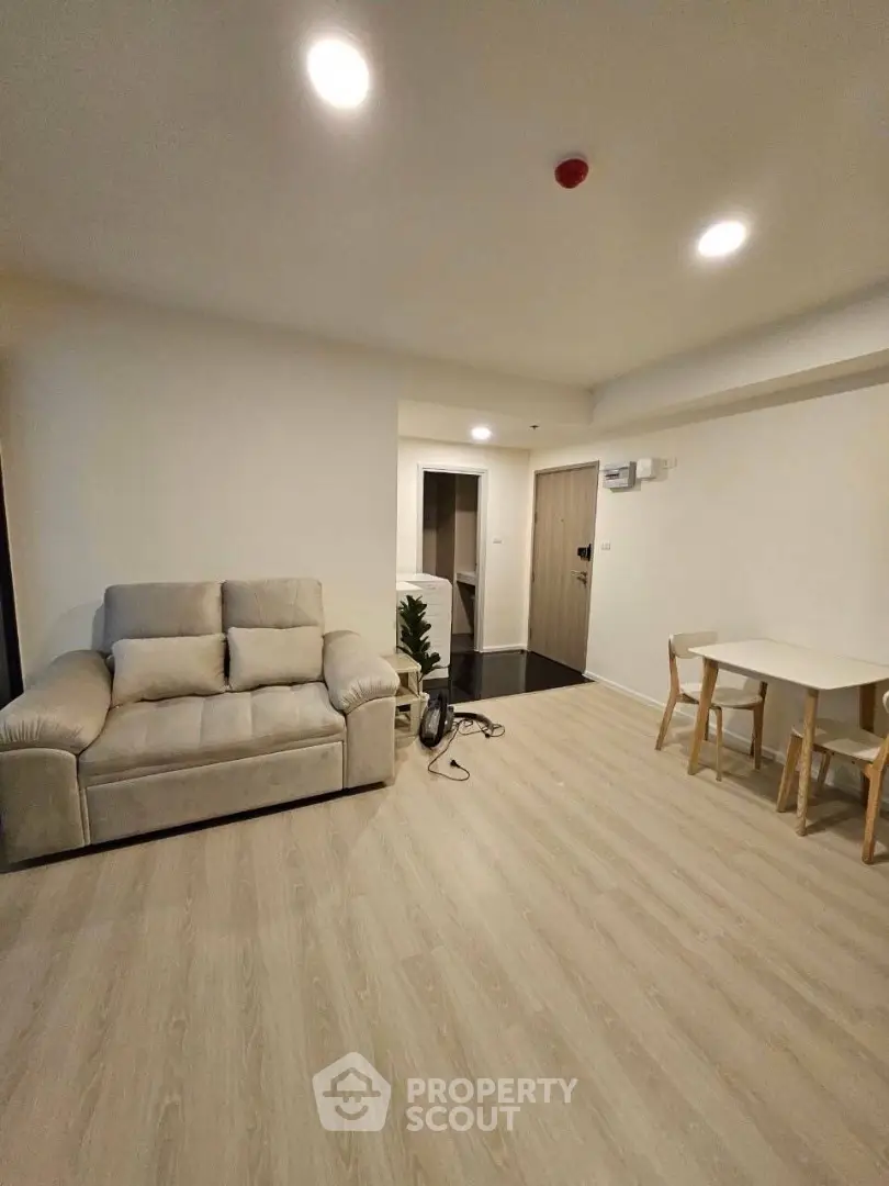 Modern living room with cozy sofa and dining area in stylish apartment