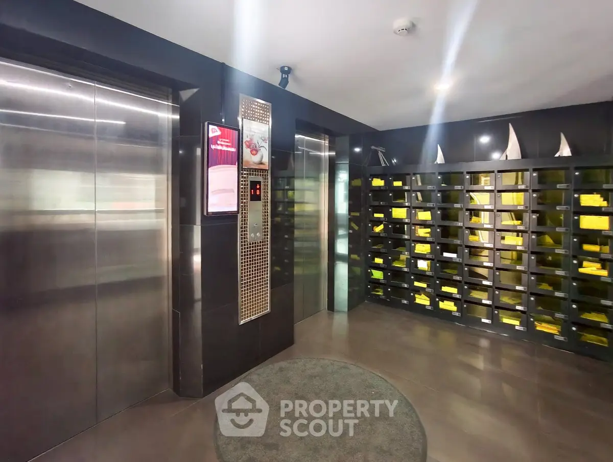 Modern apartment building lobby with sleek elevator and mailboxes