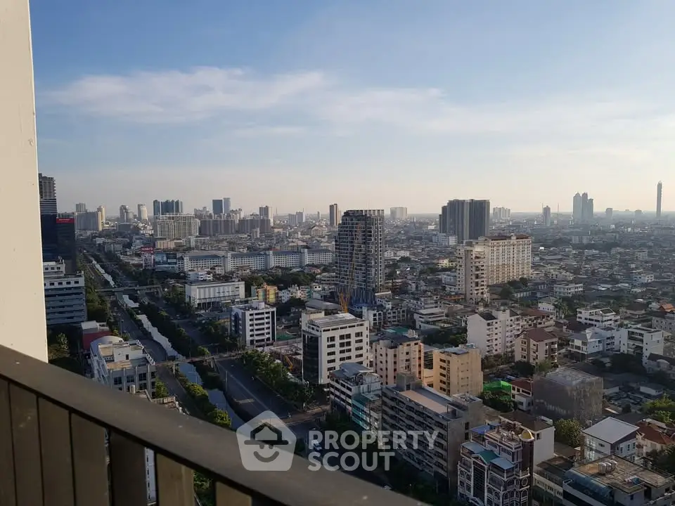 Stunning cityscape view from a high-rise balcony, showcasing urban skyline and vibrant city life.
