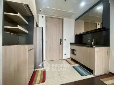 Modern kitchen with sleek cabinets and built-in appliances in a compact layout.