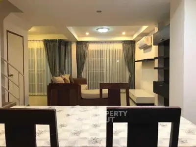 Spacious living room with modern decor and ample natural light
