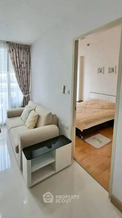 Modern apartment interior with cozy living room and bedroom, featuring stylish furniture and natural light.