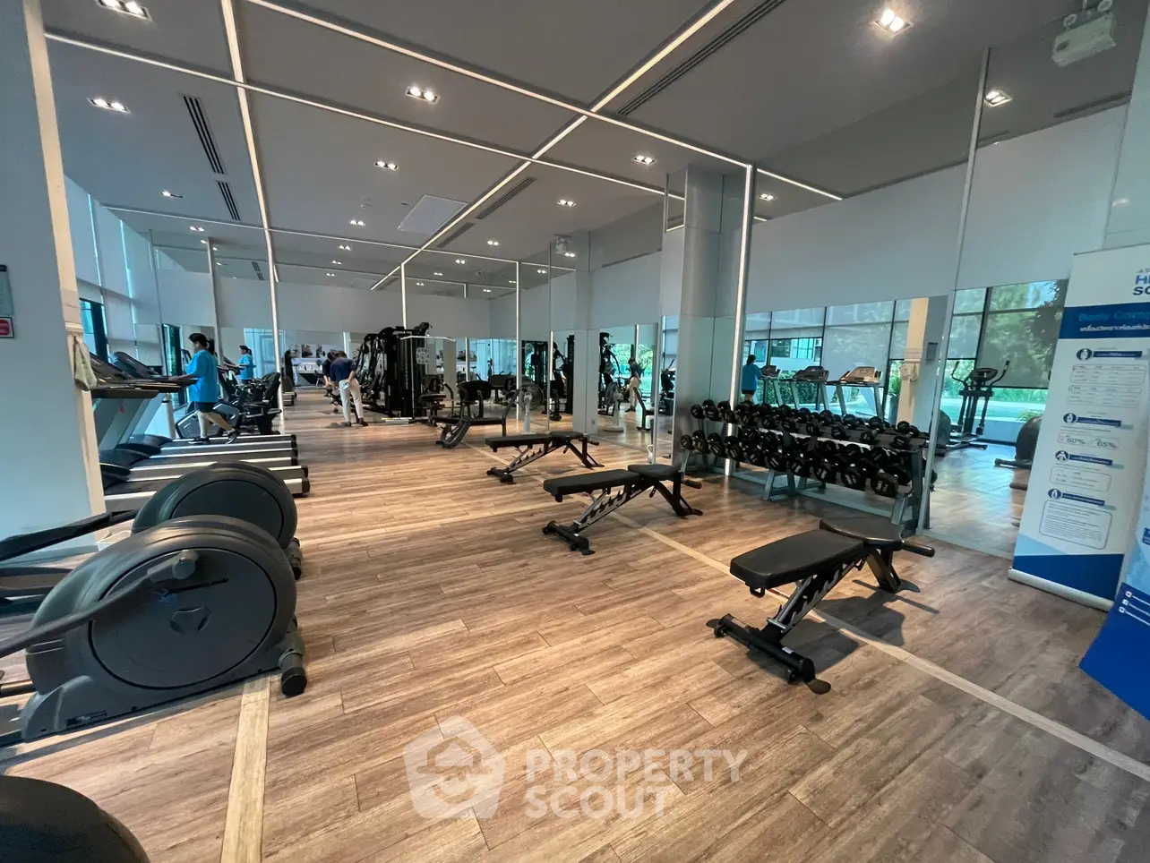 Spacious modern gym with state-of-the-art equipment and large mirrors, perfect for fitness enthusiasts.