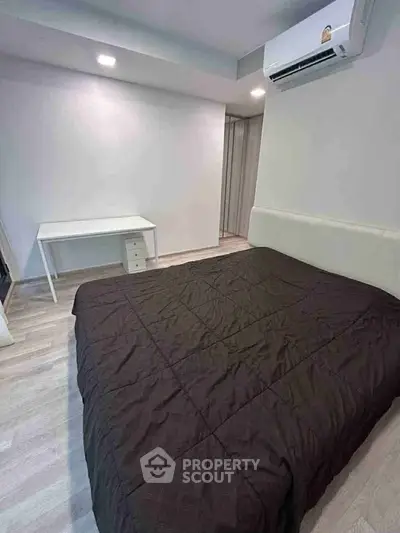 Modern bedroom with sleek design, featuring a comfortable bed and air conditioning for ultimate relaxation.