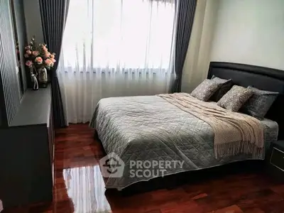 Elegant bedroom with polished wooden floors and stylish decor