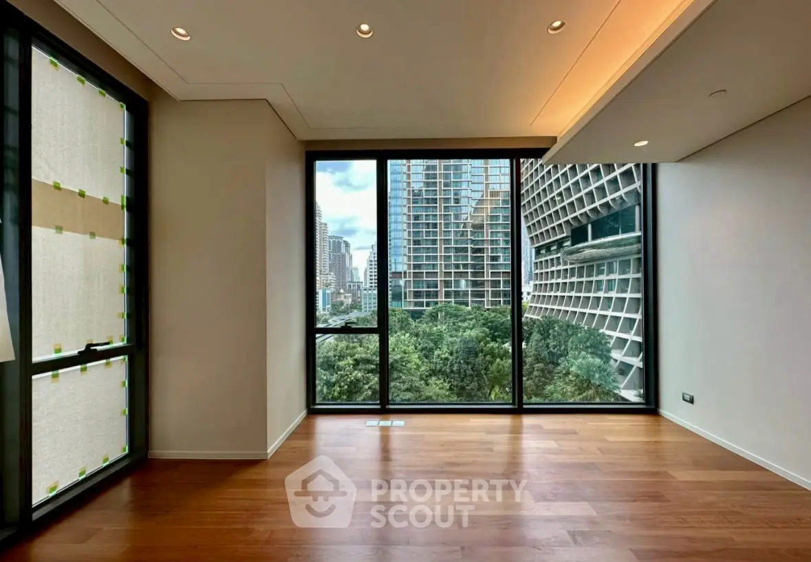 Spacious modern living room with floor-to-ceiling windows and city view