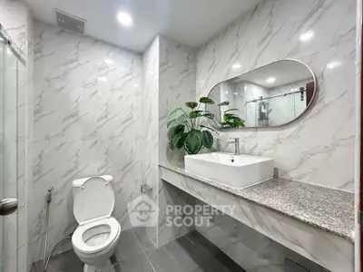 Modern bathroom with elegant marble tiles and stylish sink
