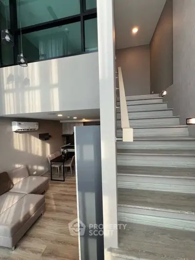 Modern duplex apartment with stylish staircase and cozy living area