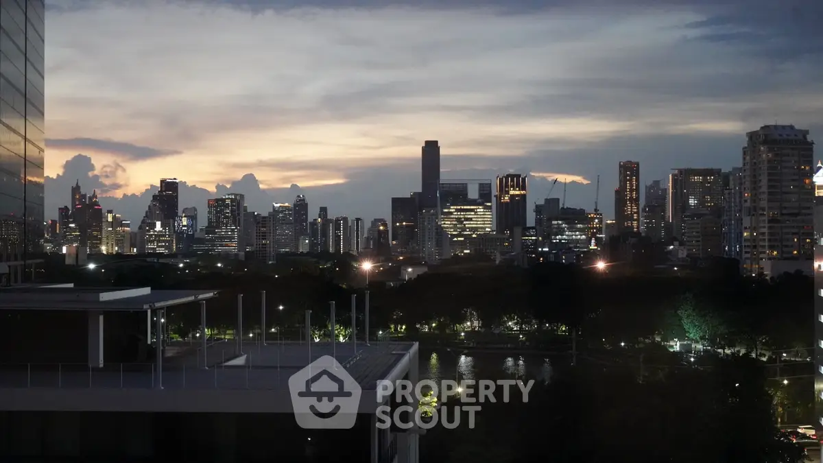 Stunning city skyline view at dusk with modern high-rise buildings and lush greenery.
