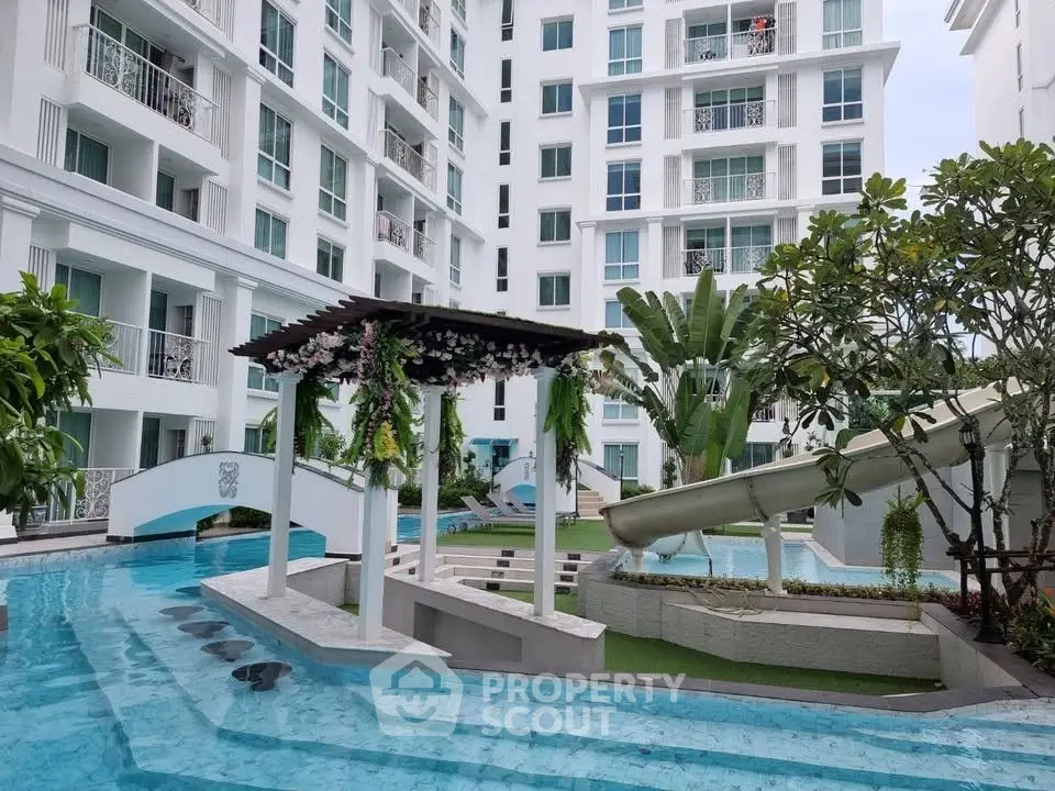 Luxurious apartment complex with stunning pool and lush greenery, perfect for modern living.