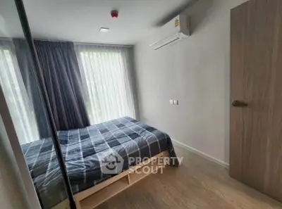 Modern bedroom with large window and air conditioning in stylish apartment.