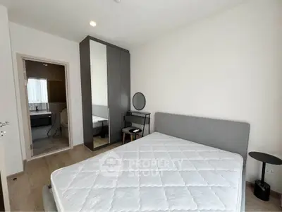 Modern bedroom with ensuite bathroom and sleek furniture