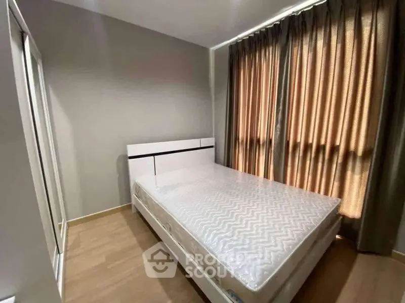 Modern bedroom with large window and stylish curtains