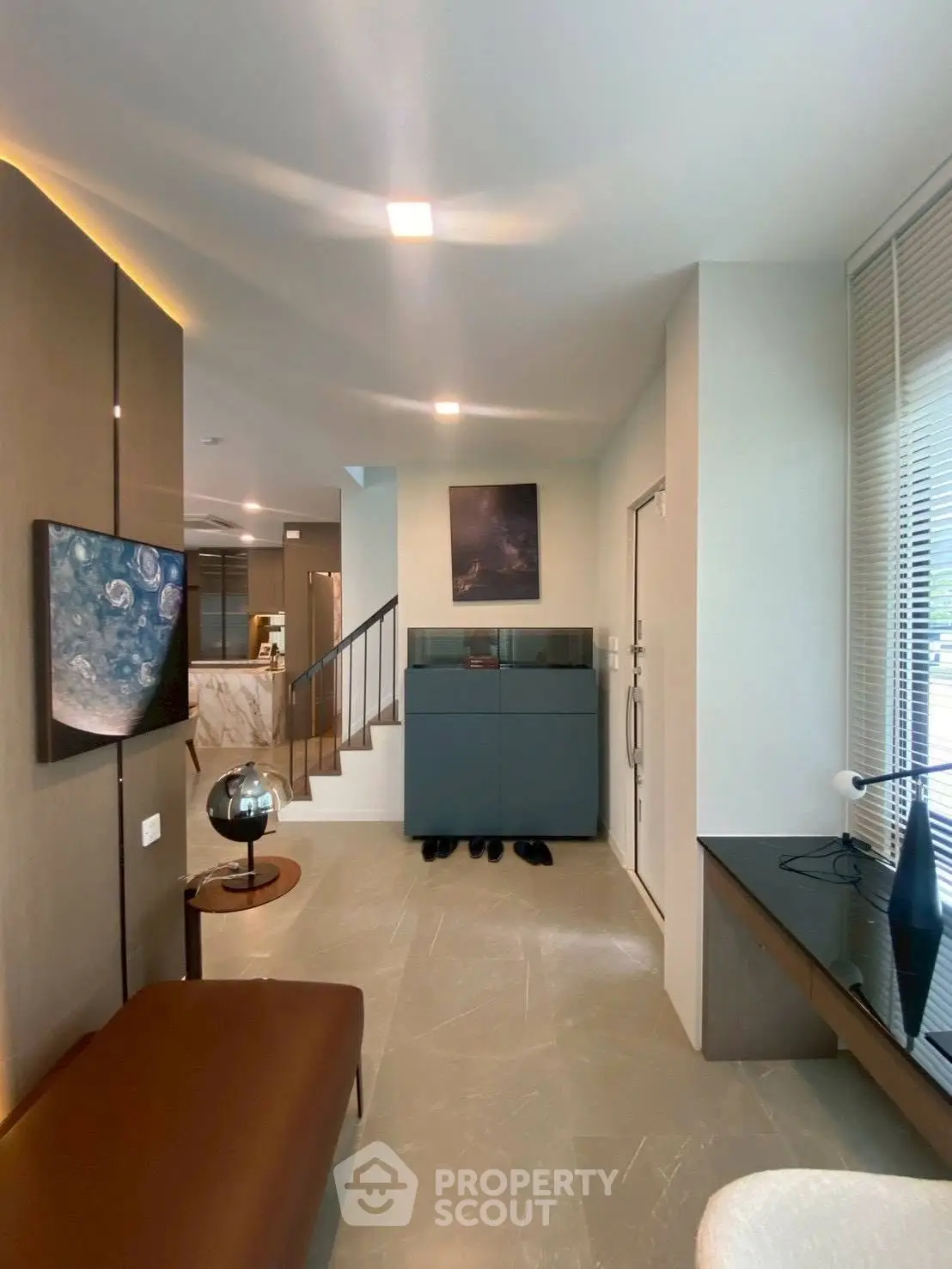 Modern living room with stylish decor and open layout, featuring sleek furniture and elegant lighting.