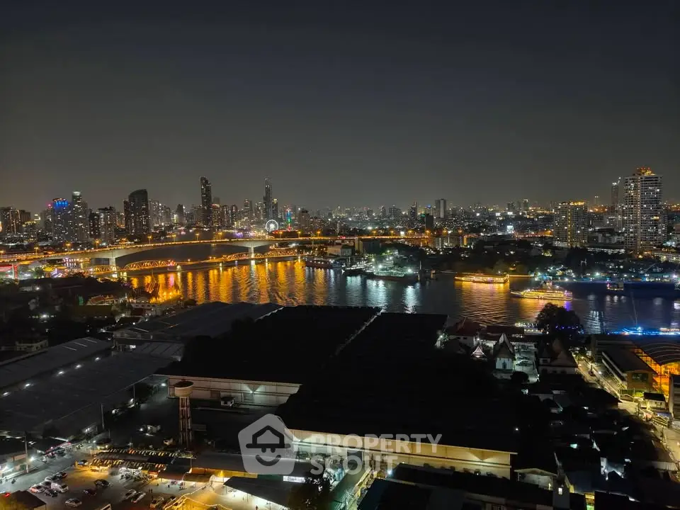 Stunning night view of city skyline and river, showcasing vibrant urban lights and serene water reflections.