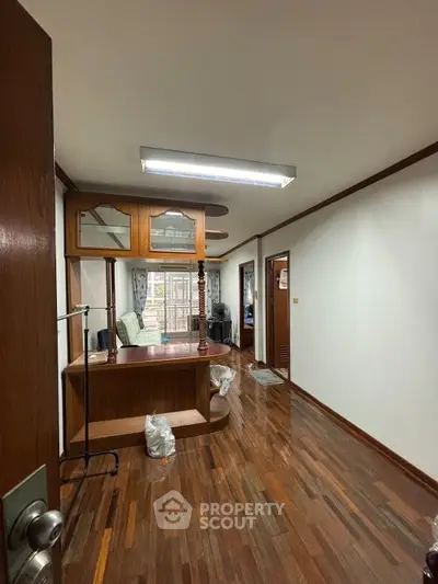 Spacious interior with wooden flooring and unique built-in shelving, perfect for modern living.