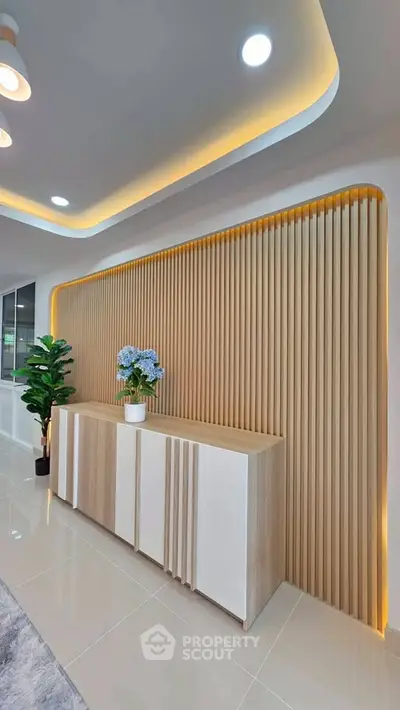 Modern interior design with elegant wooden paneling and stylish lighting in a contemporary living space.