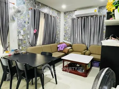 Cozy living room with modern decor, comfortable seating, and stylish dining area.