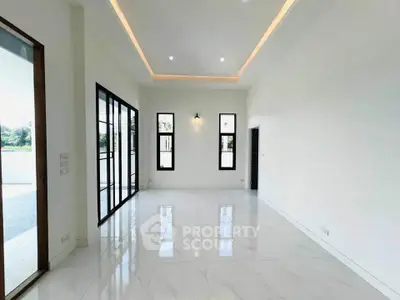 Spacious modern living room with high ceilings and large windows