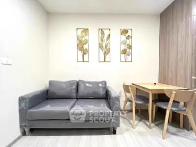 Modern living room with stylish grey sofa and elegant dining set