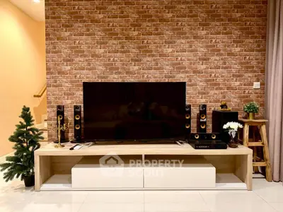 Stylish living room with modern entertainment setup and brick accent wall