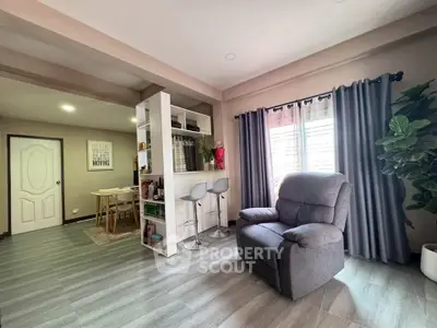 Modern living room with cozy recliner and stylish bar area, perfect for relaxation and entertaining.