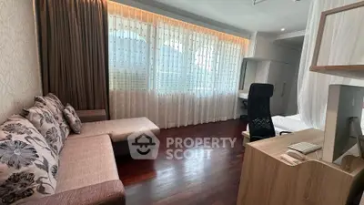 Spacious living room with modern decor and large window for natural light