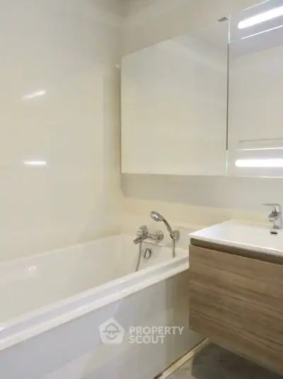 Modern bathroom with sleek fixtures and a stylish vanity unit.