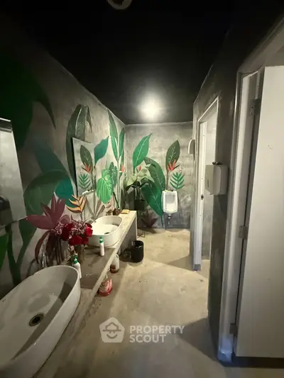 Stylish bathroom with artistic wall design and modern fixtures in a contemporary property.