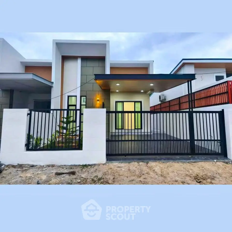 Modern single-story house with sleek design and gated entrance, perfect for contemporary living.