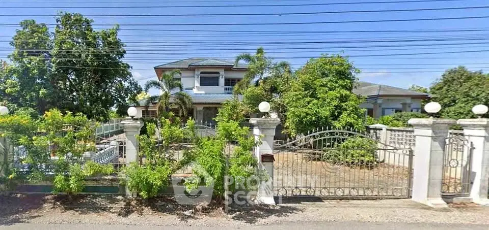Charming suburban house with lush garden and elegant gated entrance, perfect for family living.