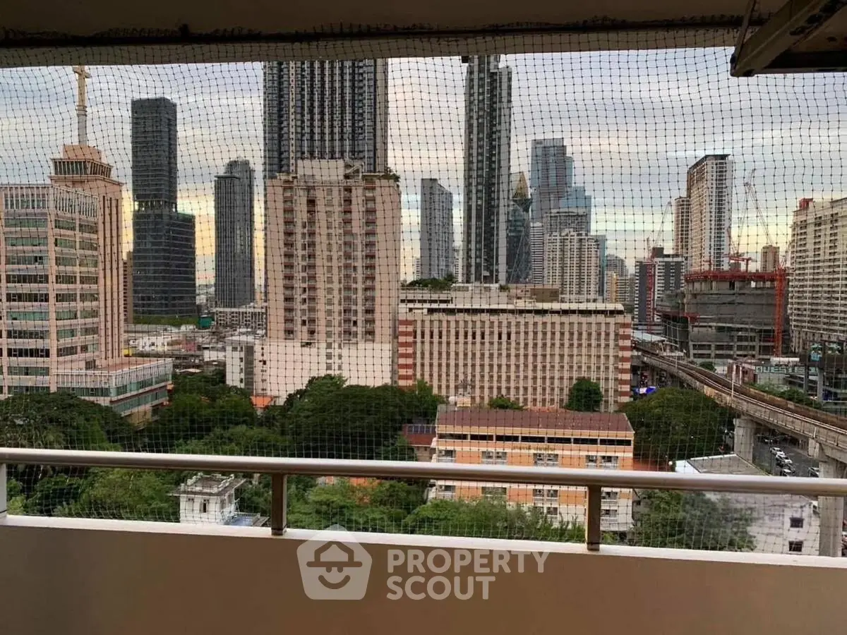 Stunning cityscape view from a high-rise balcony with urban skyline