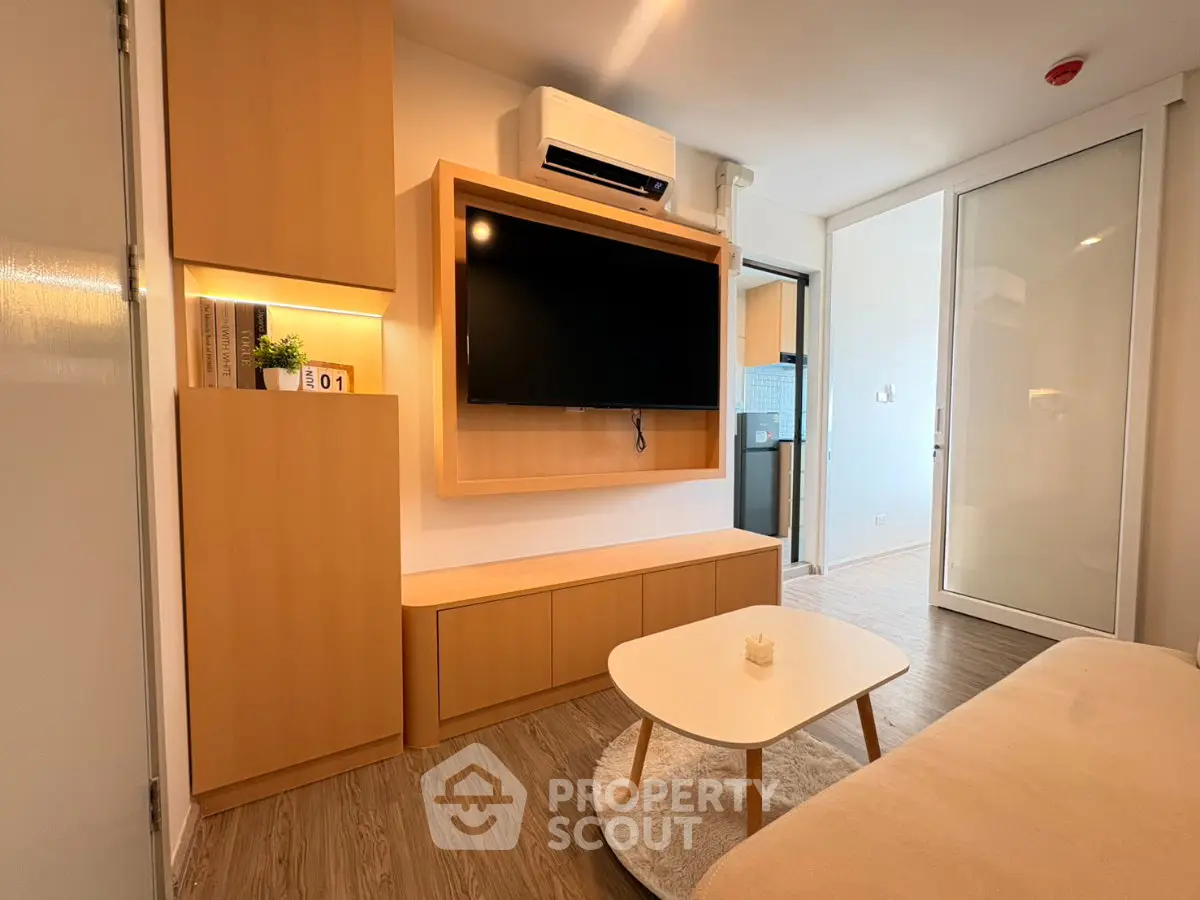 Modern living room with wall-mounted TV and stylish wooden furniture