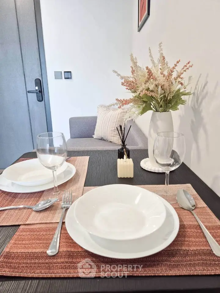 Elegant dining setup in modern living room with stylish decor and cozy ambiance.