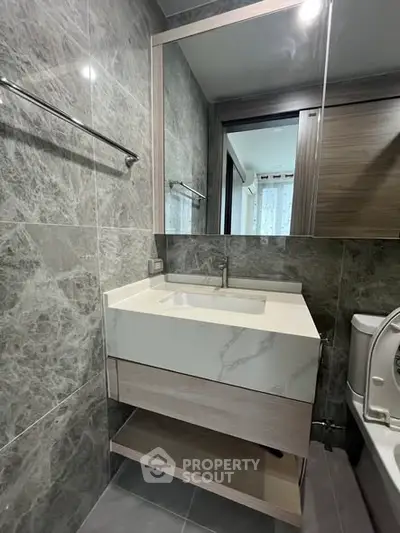Modern bathroom with sleek vanity and marble tiles