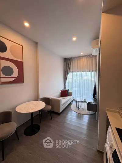 Modern living room with stylish decor and natural light, perfect for relaxation.