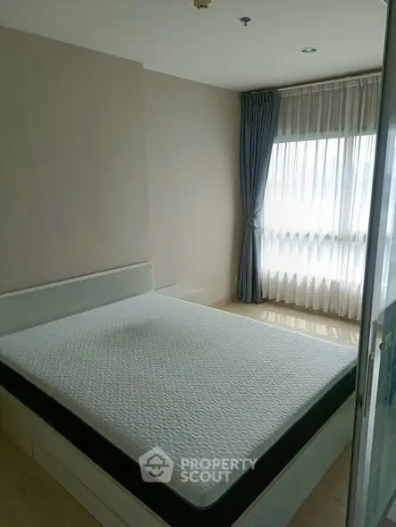 Bright and cozy bedroom with large window and elegant curtains