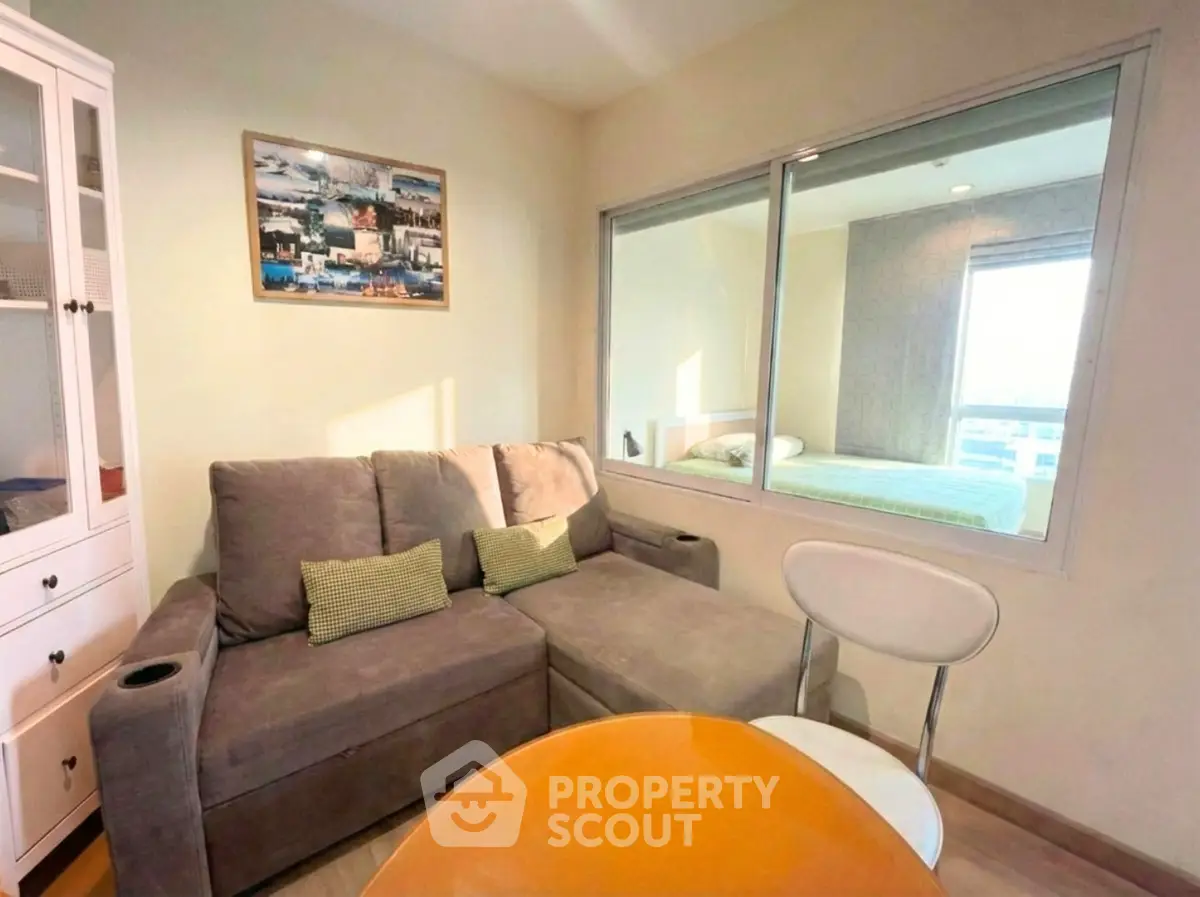 Cozy living room with modern sofa and dining area in bright apartment