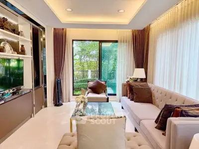 Luxurious living room with elegant decor and garden view, featuring plush seating and modern design.