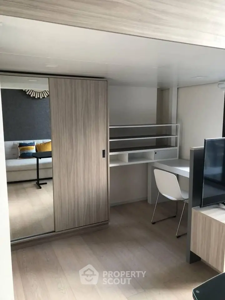 Modern apartment interior with sleek wooden finishes and built-in desk area